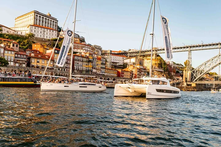 Two sailboats on Douro River near Porto's historic Ribeira district