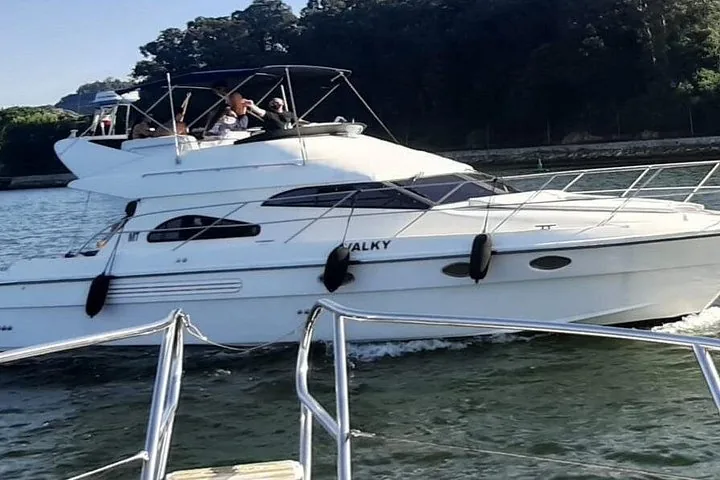 A white motor yacht named 'VALKY' cruising on the Douro River.