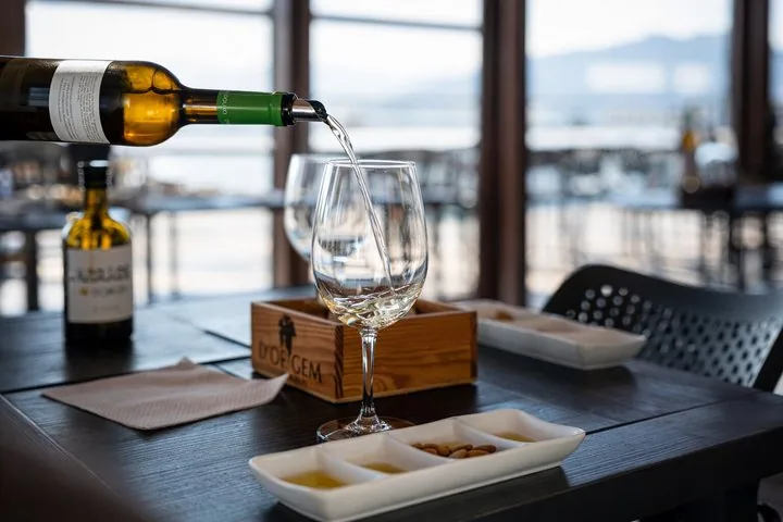 Pouring white wine into a glass during a tasting session