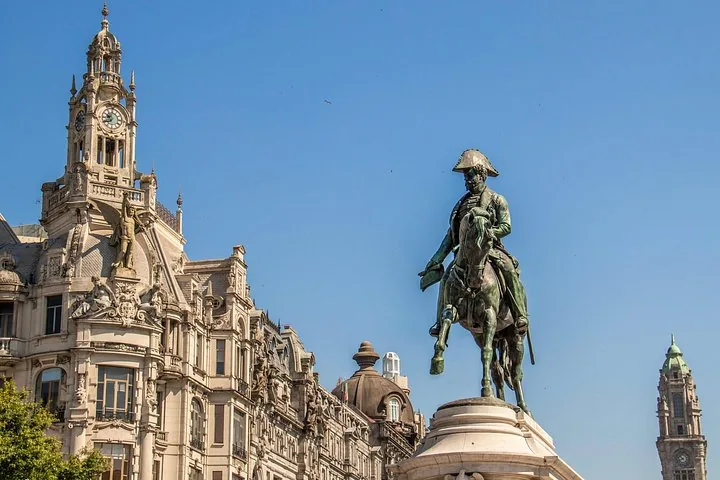 Equestrian statue of Dom Pedro IV in a city square surrounded by historic buildings